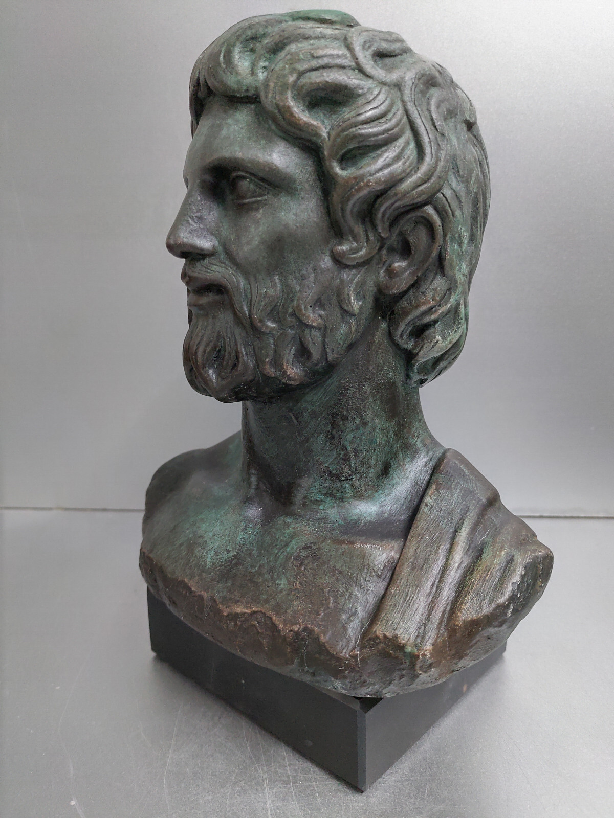 Asclepius sculpture statue on black marble base green aged color effect