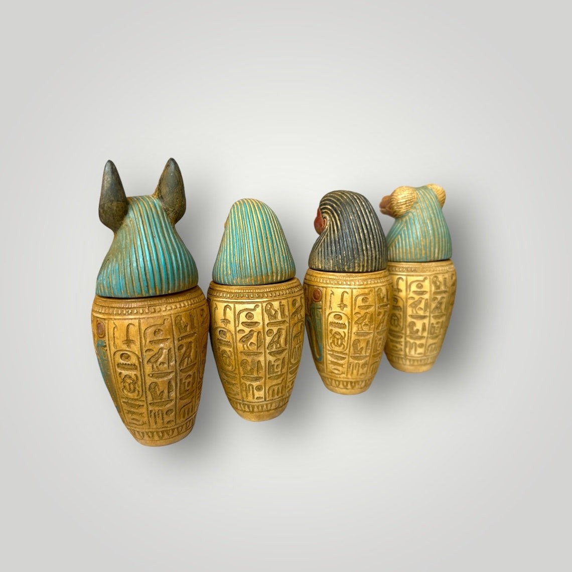 Set of four Ancient Egyptian Canopic Jars statues Hieroglyph pharaoh jars