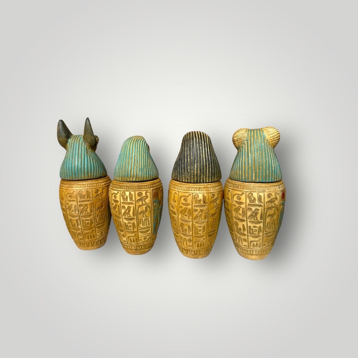Set of four Ancient Egyptian Canopic Jars statues Hieroglyph pharaoh jars