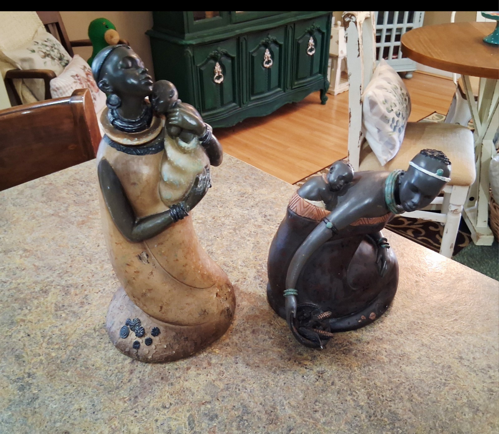 Retro stylized sculptures celebrating African heritage and maternal love. 